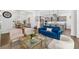 Bright and airy living room with comfortable seating, a glass coffee table, and views of the open-plan kitchen at 4712 Margutta Ct, Sarasota, FL 34240