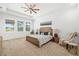 Spacious main bedroom with tray ceiling, ceiling fan and large windows overlooking lanai and backyard at 4712 Margutta Ct, Sarasota, FL 34240