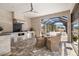 This is a luxury outdoor kitchen featuring a built-in grill, stone accents, and a ceiling fan at 4712 Margutta Ct, Sarasota, FL 34240