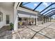Covered patio with full wall opening to the outdoor kitchen and pool area, offering seamless indoor/outdoor living at 4712 Margutta Ct, Sarasota, FL 34240