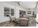 Covered patio area with comfortable seating and ceiling fans, perfect for relaxing outdoors at 4712 Margutta Ct, Sarasota, FL 34240