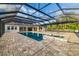 Backyard pool with connecting hot tub and covered patio overlooking the backyard at 4712 Margutta Ct, Sarasota, FL 34240