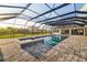 Covered, screened-in pool with built-in hot tub and an outdoor living area at 4712 Margutta Ct, Sarasota, FL 34240