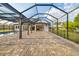 Screened-in pool with large deck and view of the home's covered outdoor living space at 4712 Margutta Ct, Sarasota, FL 34240