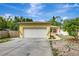 Charming home featuring a two-car garage, lush landscaping, and inviting curb appeal with a quaint front porch at 4790 70Th N St, St Petersburg, FL 33709
