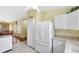 White kitchen with tile floor and dining room visible through archway at 4790 70Th N St, St Petersburg, FL 33709