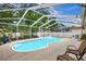 Inviting custom-shaped pool within a screened enclosure, perfect for outdoor enjoyment at 4790 70Th N St, St Petersburg, FL 33709