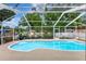 Enclosed pool with crystal clear water, a custom shape, and a safety handrail at 4790 70Th N St, St Petersburg, FL 33709