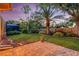 Landscaped backyard with a paver patio, lush lawn, and mature trees at 4926 Sabal Lake Cir, Sarasota, FL 34238