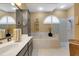 Bright bathroom featuring a large soaking tub and glass shower, with neutral tiling and modern fixtures at 4926 Sabal Lake Cir, Sarasota, FL 34238