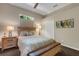 Bright bedroom featuring a full bed and wooden bedside tables with modern lamps at 4926 Sabal Lake Cir, Sarasota, FL 34238
