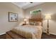 Comfortable bedroom featuring a full bed with side tables and neutral decor at 4926 Sabal Lake Cir, Sarasota, FL 34238