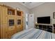 Bright bedroom featuring built-in wooden storage cabinets and a calming blue and white striped bedspread at 4926 Sabal Lake Cir, Sarasota, FL 34238