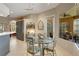 Cozy dining area features a glass table set, view of the lanai and living room with a wine rack at 4926 Sabal Lake Cir, Sarasota, FL 34238