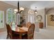 A formal dining area leads to the front entry, featuring a stylish light fixture and plenty of natural light at 4926 Sabal Lake Cir, Sarasota, FL 34238