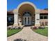 Attractive building with a tile roof, stone columns, manicured lawn and landscaping at 4926 Sabal Lake Cir, Sarasota, FL 34238