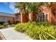 Well-manicured landscaping complements the terracotta exterior of this lovely home at 4926 Sabal Lake Cir, Sarasota, FL 34238