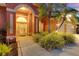 Beautiful house with arched front entrance and lush manicured landscaping at 4926 Sabal Lake Cir, Sarasota, FL 34238