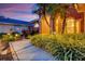 A stone walkway leads to the arched entrance of this building surrounded by manicured plants at 4926 Sabal Lake Cir, Sarasota, FL 34238