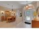 Inviting foyer leads to a dining area, showcasing a blend of tile and wood flooring at 4926 Sabal Lake Cir, Sarasota, FL 34238