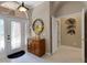 Welcoming foyer featuring a decorative mirror, console table, and tile flooring at 4926 Sabal Lake Cir, Sarasota, FL 34238