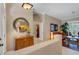 An upper hallway features a round mirror, a console table, and an entryway leading to the living room at 4926 Sabal Lake Cir, Sarasota, FL 34238