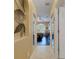 Hallway featuring tile flooring, leading into rooms with dark hardwood floors and arched windows at 4926 Sabal Lake Cir, Sarasota, FL 34238