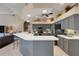 The bright kitchen features granite counters, bar seating, stainless steel appliances, and lots of storage at 4926 Sabal Lake Cir, Sarasota, FL 34238