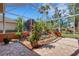 Enclosed lanai highlighting the rock garden, serene water feature, and tropical landscaping at 4926 Sabal Lake Cir, Sarasota, FL 34238