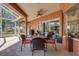 Screened lanai with brick flooring, furnished dining table and views of the lush landscaped backyard at 4926 Sabal Lake Cir, Sarasota, FL 34238
