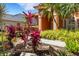 Tropical landscaping surrounds the home, adding pops of color to the exterior at 4926 Sabal Lake Cir, Sarasota, FL 34238