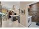 View of the kitchen with white countertops, as well as the laundry room with rustic wood wall paneling at 4926 Sabal Lake Cir, Sarasota, FL 34238