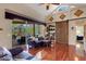 Spacious living room with hardwood floors, high ceilings, lanai access, and rustic barn door feature at 4926 Sabal Lake Cir, Sarasota, FL 34238