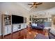 Open-concept living room boasting hardwood floors, entertainment center, and kitchen access at 4926 Sabal Lake Cir, Sarasota, FL 34238