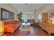 Comfortable living room featuring hardwood floors, a cozy sofa, and shuttered sliding glass doors at 4926 Sabal Lake Cir, Sarasota, FL 34238