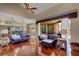 Hardwood floors flow throughout the living room with lanai access, kitchen access, and comfortable seating at 4926 Sabal Lake Cir, Sarasota, FL 34238
