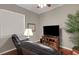 Comfortable living room featuring a leather recliner, hardwood floors, a flat-screen TV, and a plant at 4926 Sabal Lake Cir, Sarasota, FL 34238