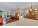 Open-concept living room and dining area with hardwood floors, a large slider, and stylish furniture at 4926 Sabal Lake Cir, Sarasota, FL 34238