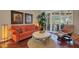 Bright living room with hardwood floors, shuttered sliding glass doors, and a comfortable sofa at 4926 Sabal Lake Cir, Sarasota, FL 34238