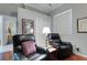 Relaxing sitting room featuring two leather recliners, hardwood floors, and a bright window at 4926 Sabal Lake Cir, Sarasota, FL 34238