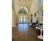 An open airy lobby with hardwood floors and stylish decorations at 4926 Sabal Lake Cir, Sarasota, FL 34238