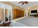 Large main bedroom with ceiling fan, wood flooring, built-in wardrobe and access to the patio at 4926 Sabal Lake Cir, Sarasota, FL 34238