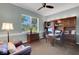 This is an office space featuring a ceiling fan and dark wood desk with matching drawers at 4926 Sabal Lake Cir, Sarasota, FL 34238