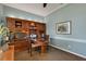 This is an office area with gray-blue paneled walls, a dark wood desk, and a cabinet at 4926 Sabal Lake Cir, Sarasota, FL 34238