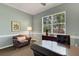 This is a view of an office space with wood paneled walls, a sofa, and a dark wood desk at 4926 Sabal Lake Cir, Sarasota, FL 34238