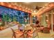 Expansive covered patio with outdoor seating, ceiling fan, and views of a serene backyard at 4926 Sabal Lake Cir, Sarasota, FL 34238