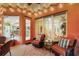 Inviting patio with string lights, comfortable seating, and view through windows to home interior at 4926 Sabal Lake Cir, Sarasota, FL 34238