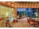 Relaxing covered patio with a tranquil rock garden feature and outdoor dining area at 4926 Sabal Lake Cir, Sarasota, FL 34238