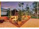 Backyard rock garden with lush tropical plants, a small waterfall, and unique statues at 4926 Sabal Lake Cir, Sarasota, FL 34238