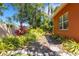 Beautiful backyard with lush landscaping, a stone path, and privacy hedging for a serene and peaceful outdoor setting at 4926 Sabal Lake Cir, Sarasota, FL 34238